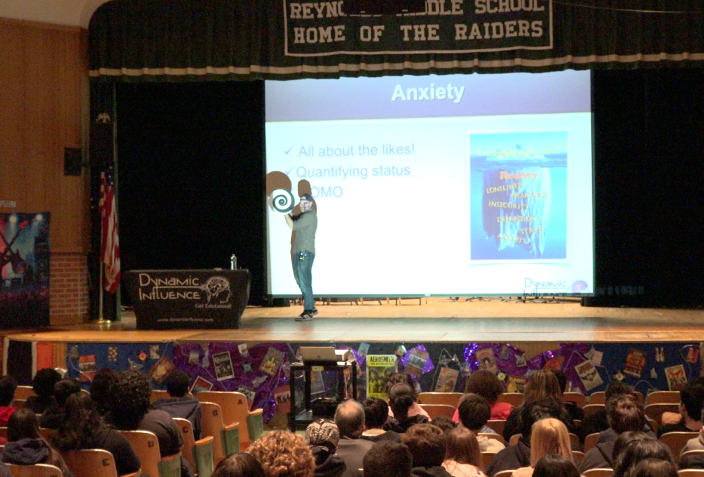 school assembly discusses teen screen time impact on mental health